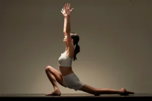 Person stretching in a living room in the evening with their phone set face down